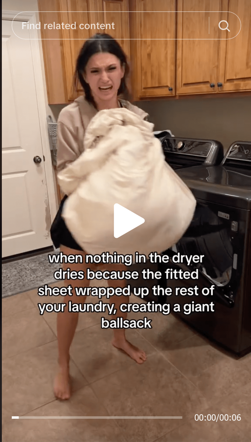 Angry woman removes a giant sheet wad of laundry saying when nothing in the dryer dries because the fitted sheet wrapped up the rest of your laundry creating a giant ballsack a problem Wad-Free for Bed Sheets solves
