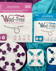Wad-Free Combo Pack - includes Wad-Free for Bed Sheets and Wad-Free for Blankets and Duvet Covers the blanket version is vivid orchid with a white round disc attached to a purple blanket. The bed sheet version is a smaller blue package and two Wad-Free squares are attached to blue and teal sheets