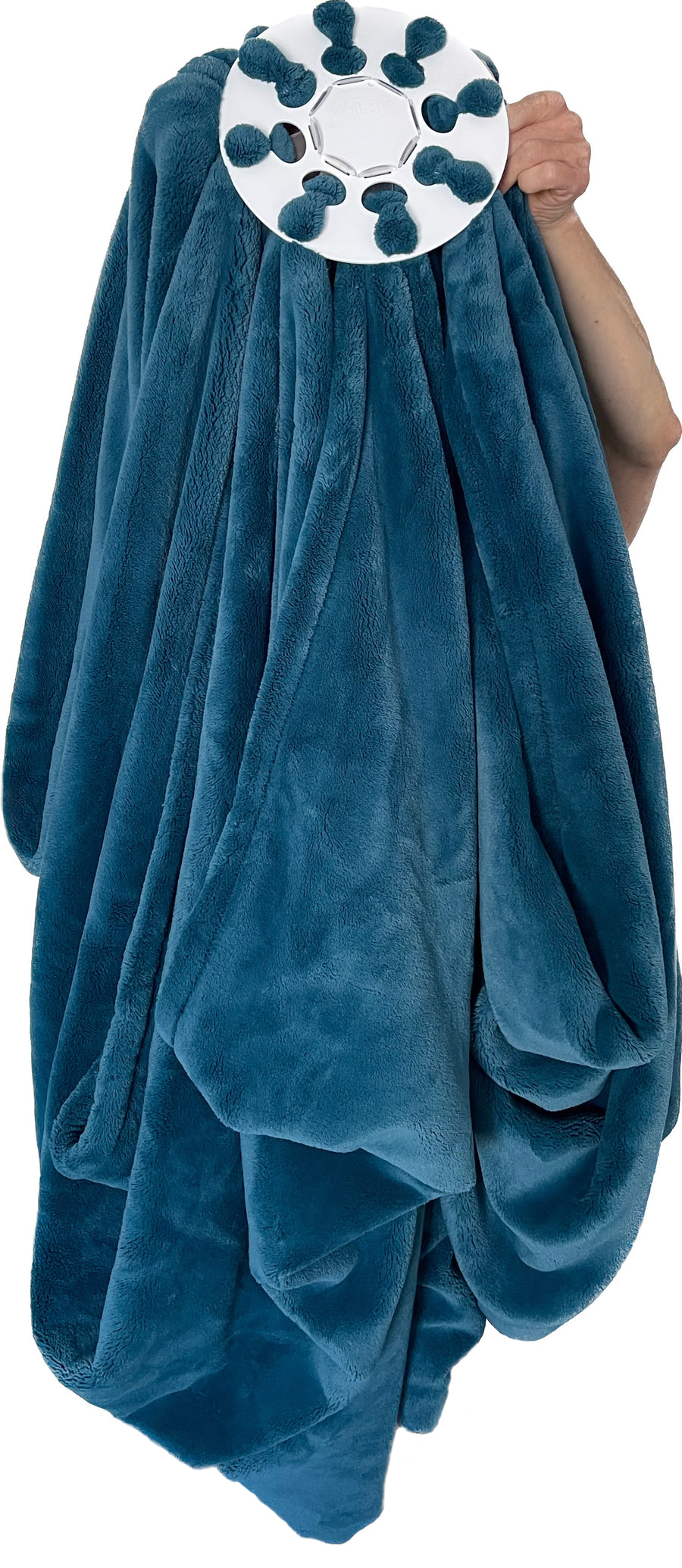 Wad-Free for Blankets and Duvet Covers shown attached to teal plush blanket and held up by a hand